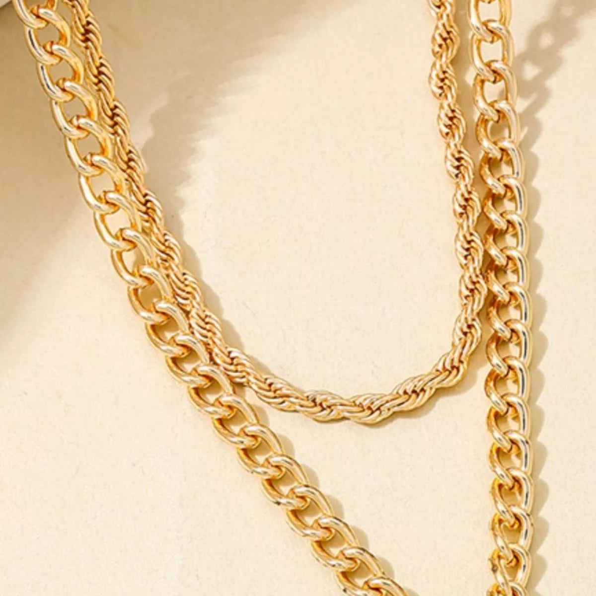 Layered gold chain cross pendant necklace from Plush Fashion Hub, featuring multiple delicate gold chains and a cross pendant.