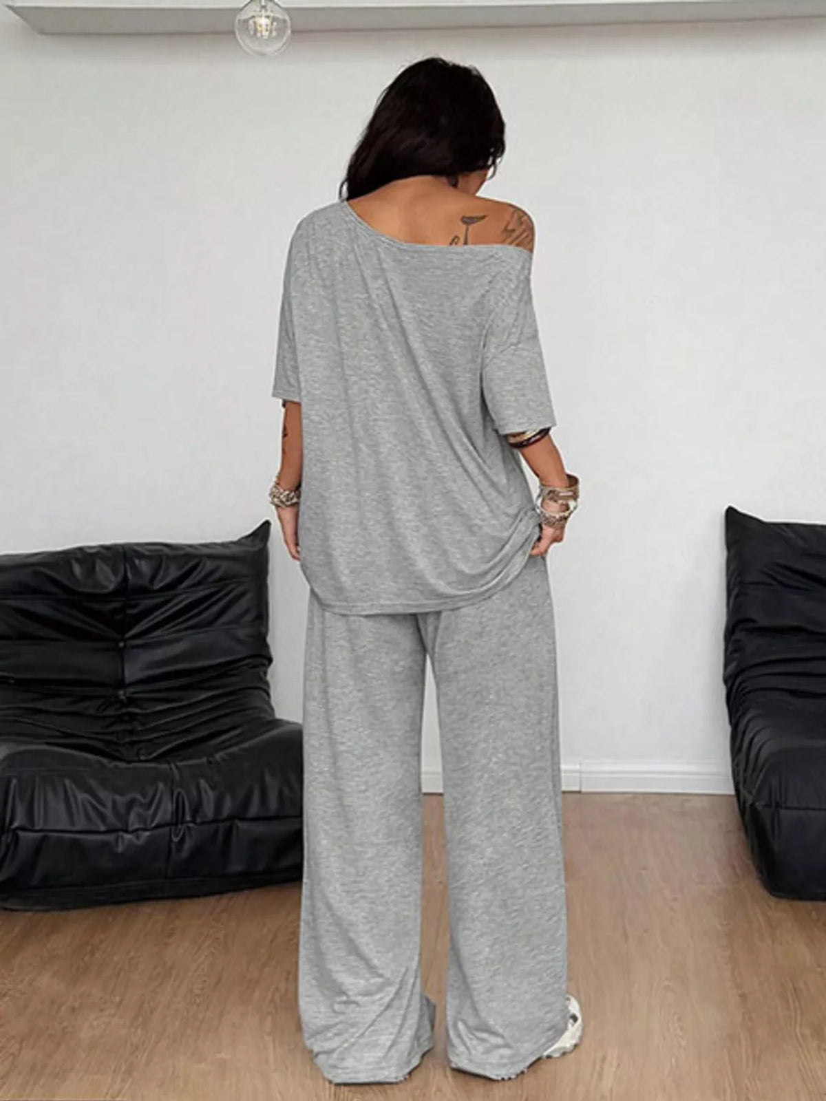 Plus size one-shoulder top and drawstring pants set from Trendsi, featuring a stylish matching outfit with a relaxed fit.