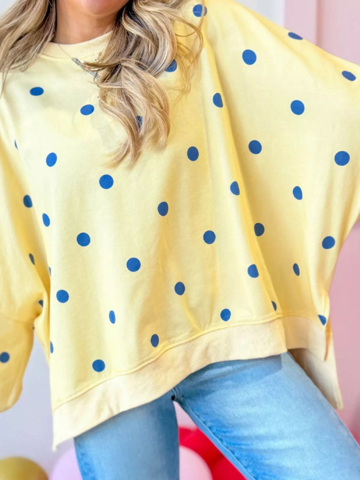 Polka dot oversized sweatshirt with side slit from Trendsi, featuring a relaxed fit and casual style.