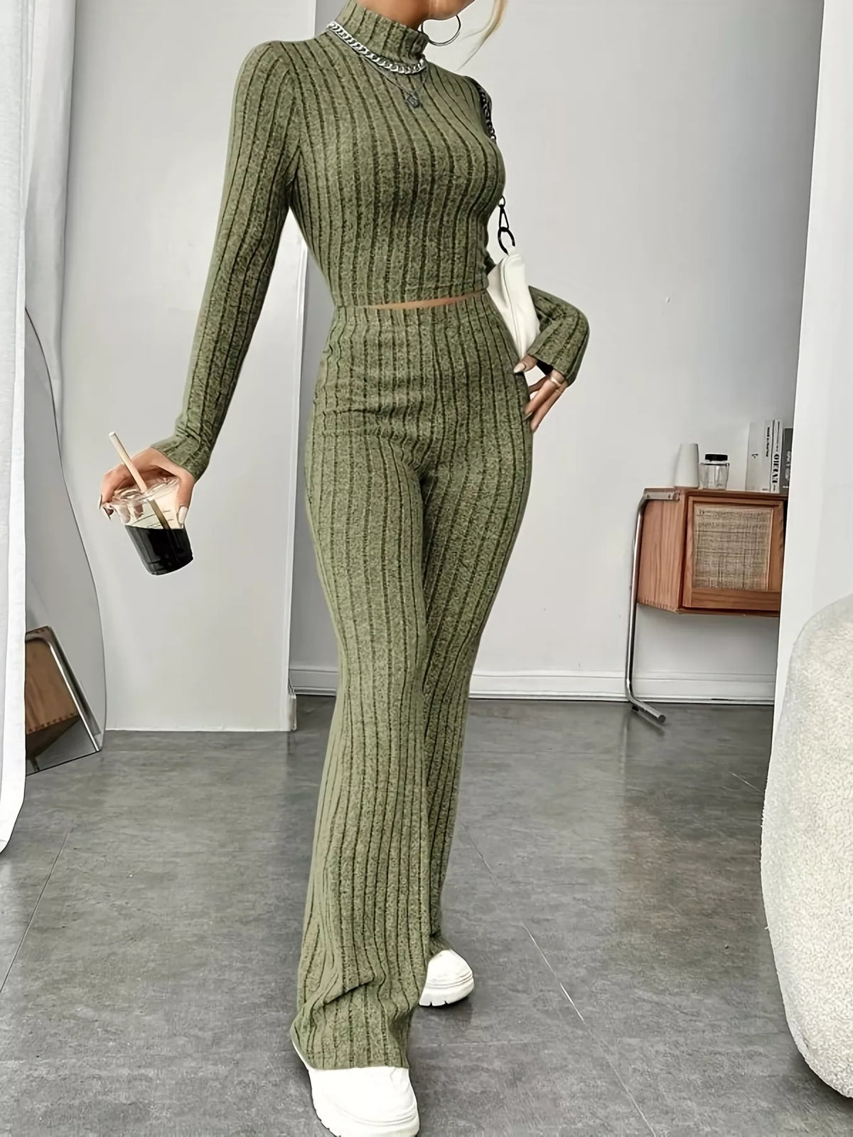 Ribbed turtleneck crop top and flare pants sweater set by Trendsi, featuring a fitted crop top and wide-leg pants in soft knit fabric.