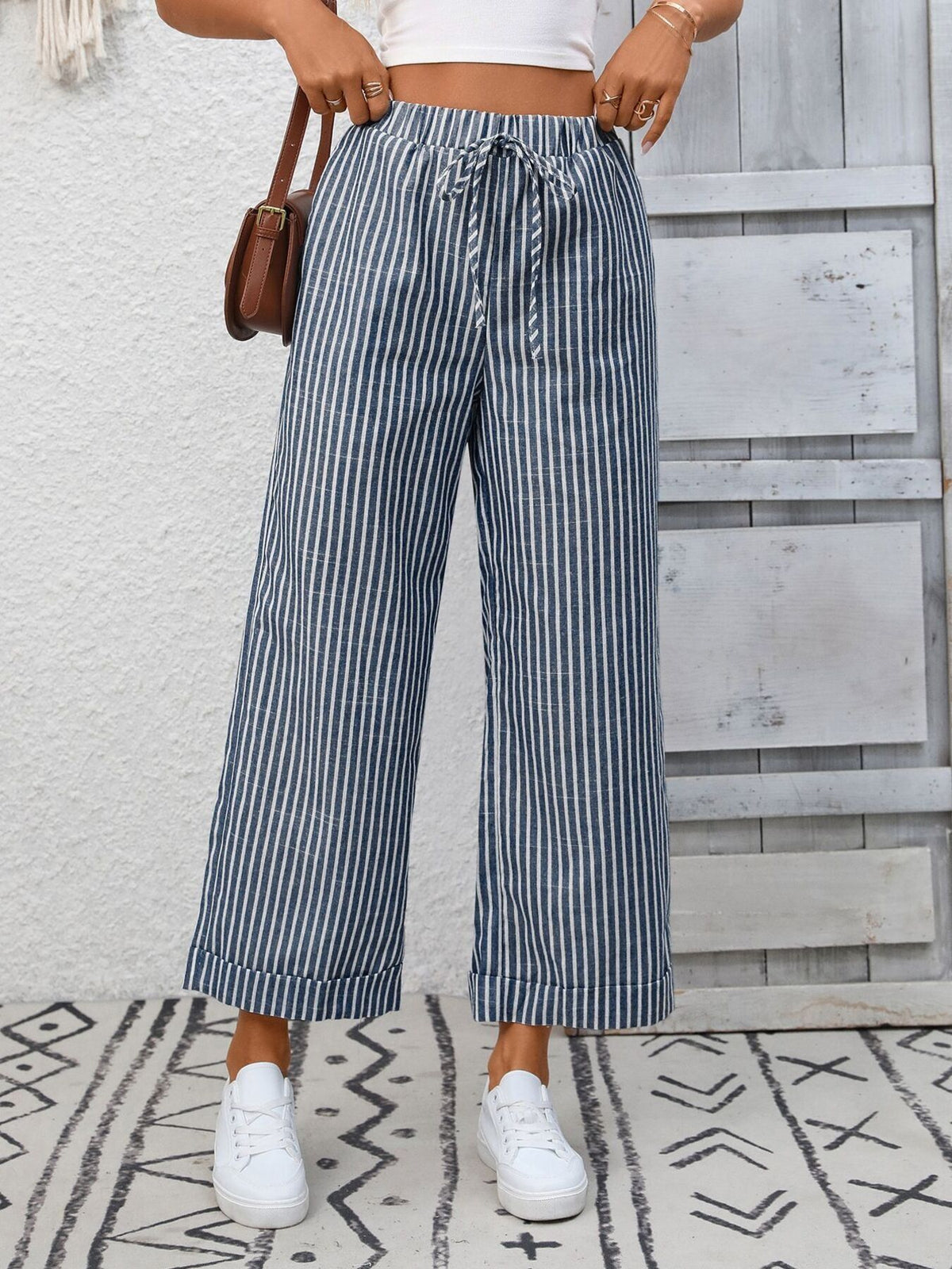 Women’s striped wide-leg drawstring pants with pockets by Plush Fashion Hub, shown in a relaxed fit with a comfortable waistband.