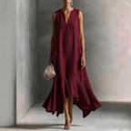Women's deep V-neck sleeveless asymmetrical maxi dress with patchwork design by FitiqueFit, featuring flowing fabric and unique hemline.