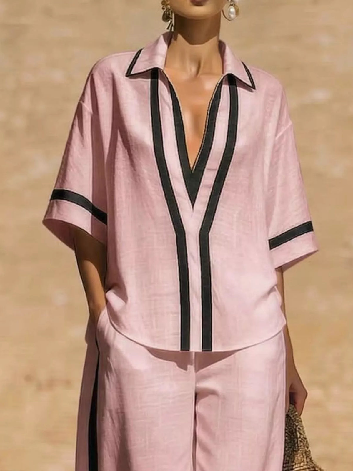Plus size full contrast trim top and pants set by Trendsi, featuring a stylish matching outfit with bold trim details.