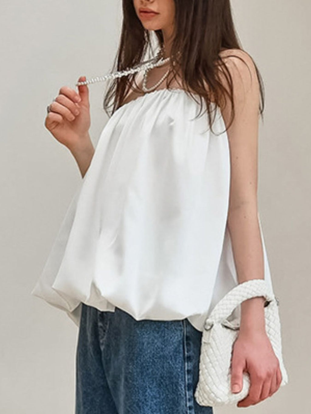 Women’s strapless bubble hem tube top by Trendsi, featuring a sleek minimalist design and trendy crop top style, shown in the image.