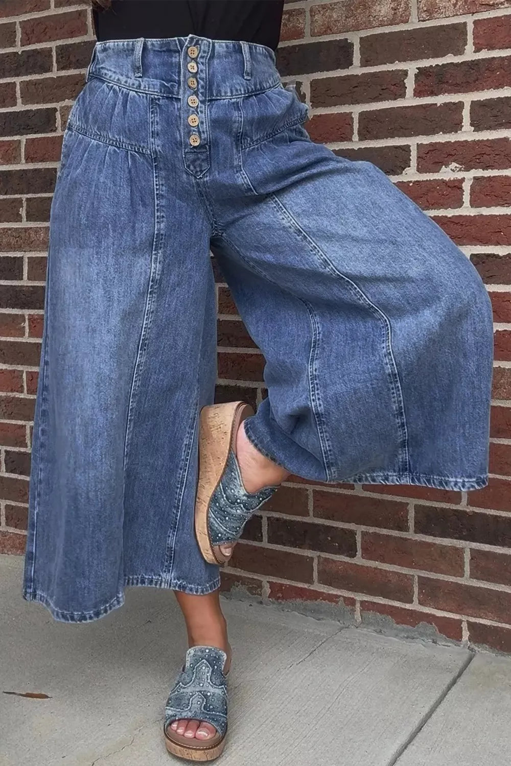 High-waisted wide-leg button-fly jeans in classic cotton denim with visible stitching and relaxed fit, designed by Trendsi.