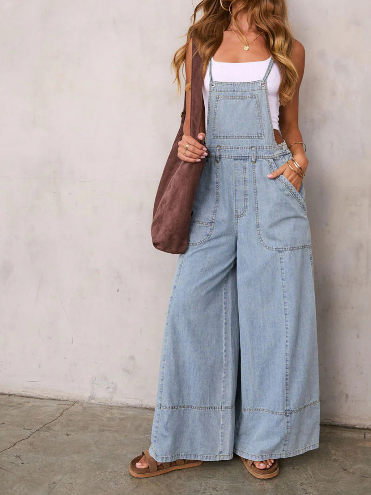 Women's relaxed fit wide leg denim overalls jumpsuit by Plush Fashion Hub, made of cotton blend fabric, shown in natural standing pose.