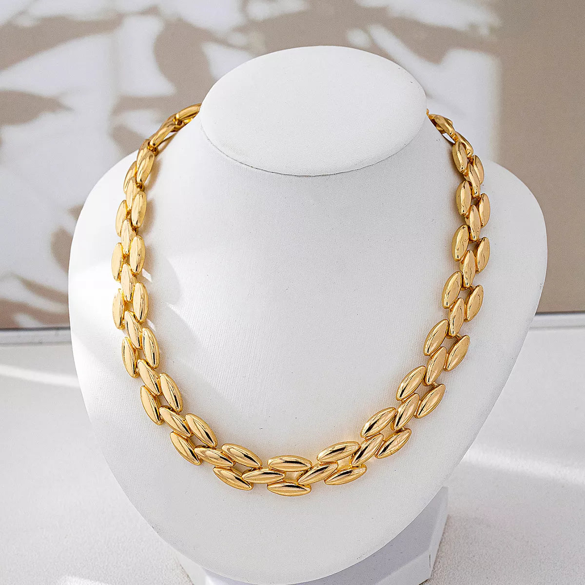 Gold-plated chunky necklace with bold links, stylish jewelry piece from Plush Fashion Hub, close-up view of the necklace.