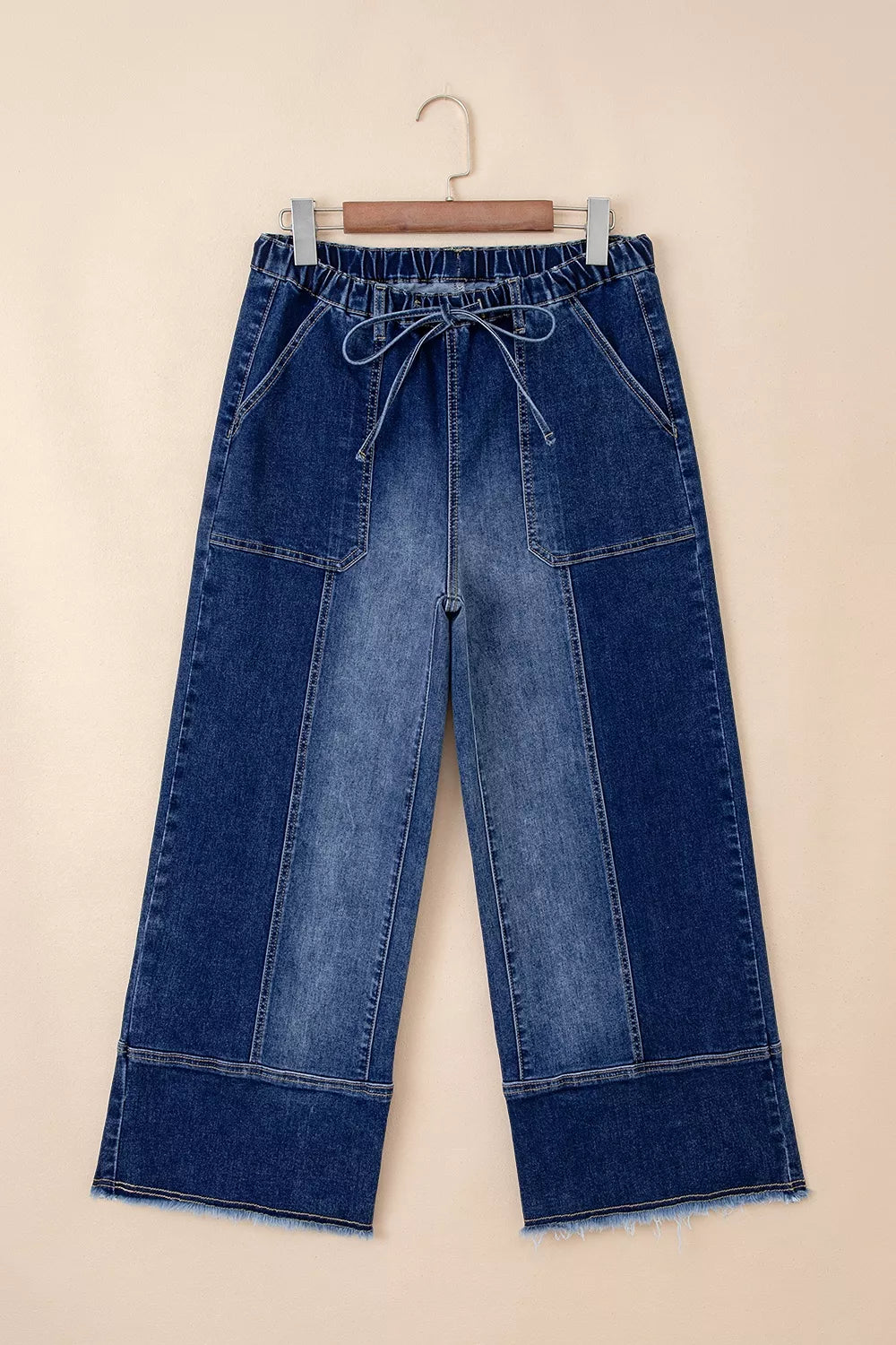 Wide-leg denim pants with drawstring waist, seam details, and raw hem from Plush Fashion Hub, showcasing relaxed fit and casual style.