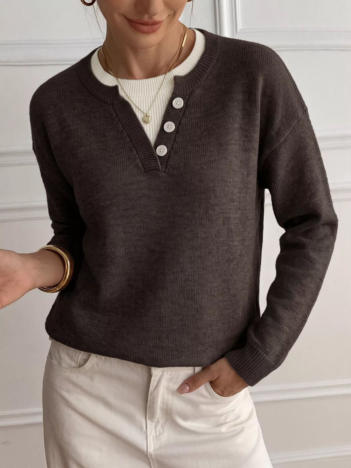 Ribbed knit sweater with button placket by Trendsi, featuring a cozy, textured design and long sleeves in a neutral color.