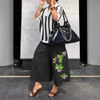Women's wide-leg cargo pants by Plush Fashion Hub featuring zipper and button details, casual style with practical pockets.