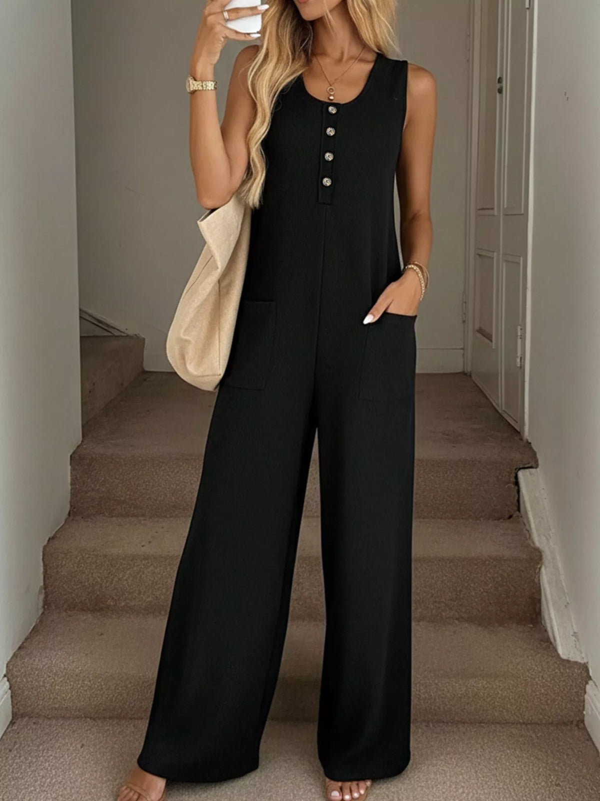Sleeveless button-front wide-leg jumpsuit by Plush Fashion Hub, shown in a stylish, flowy design with a fitted waist and shoulder straps.