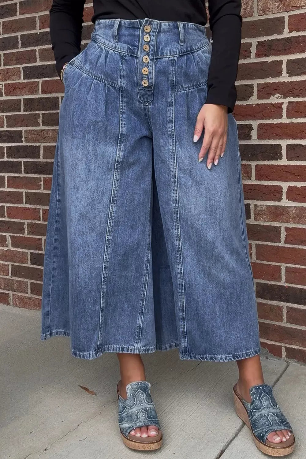High-waisted wide-leg button-fly jeans in classic cotton denim, featuring a relaxed fit and front pockets.