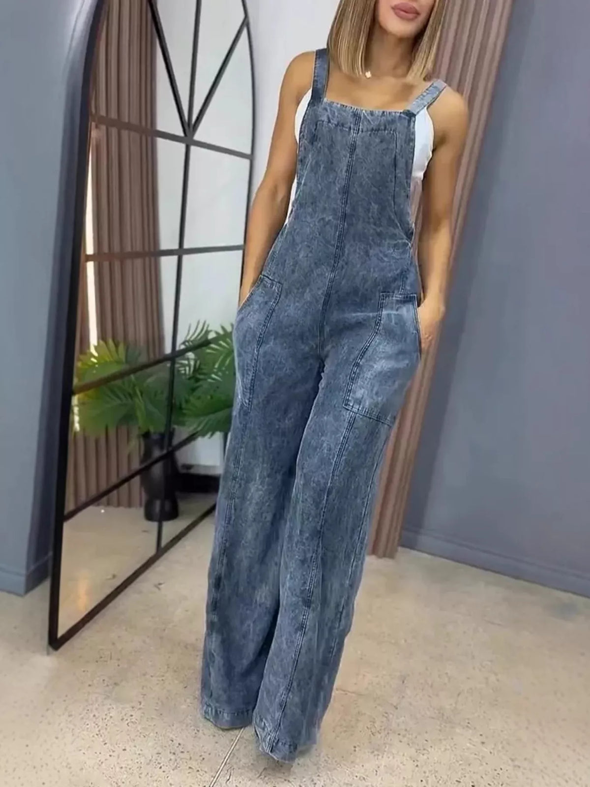 Blue wide-leg denim overalls by Plush Fashion Hub, full-length one-piece jumpsuit with adjustable straps and front pockets.