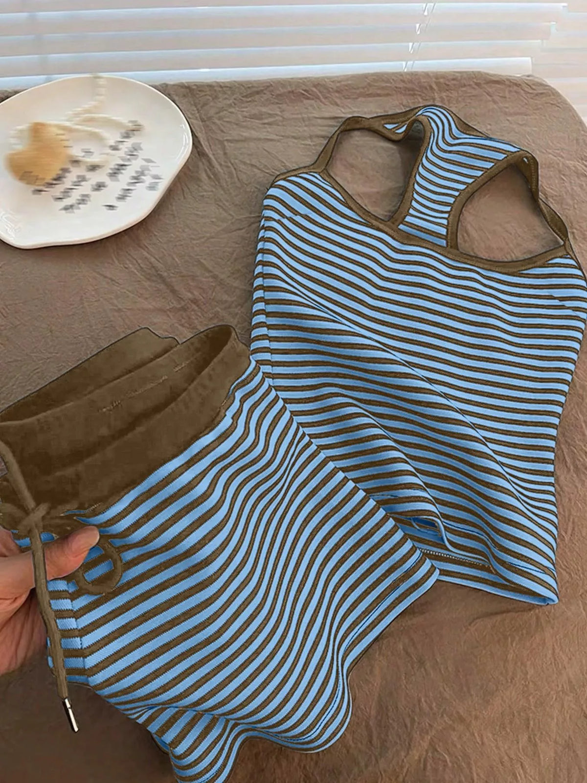 Striped tank top and shorts set by Plush Fashion Hub, casual summer outfit with blue and white stripes, displayed on a hanger.