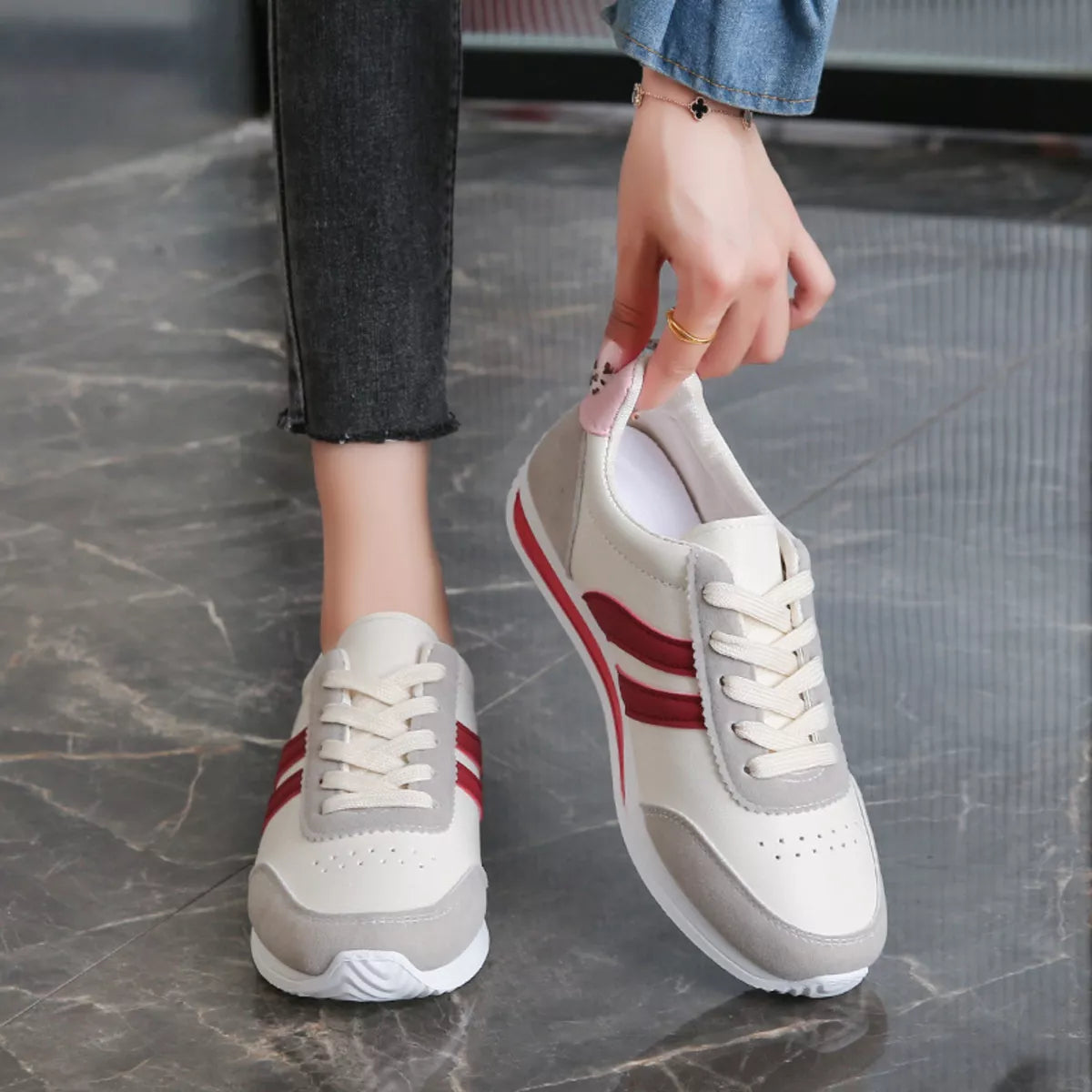 Women’s round toe lace-up sneakers by Trendsi, showing a stylish pair of casual sneakers with white laces and a white rubber sole.