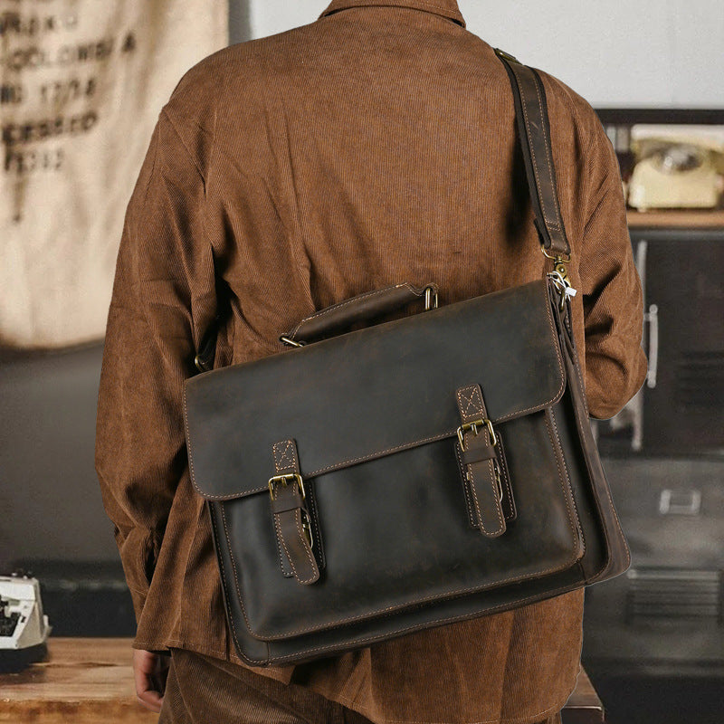 Pi-Mart top layer leather one-shoulder crossbody laptop bag with sleek design and adjustable strap, ideal for carrying laptops and essentials.