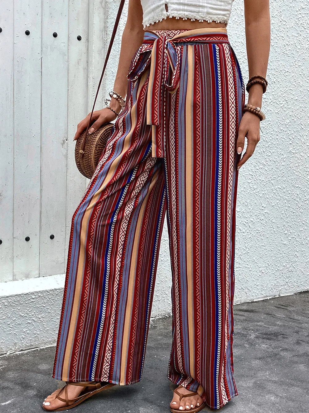 Plush Fashion Hub geometric tied wide-leg pants with bold pattern, high waist, and flowing wide-leg design on a model.