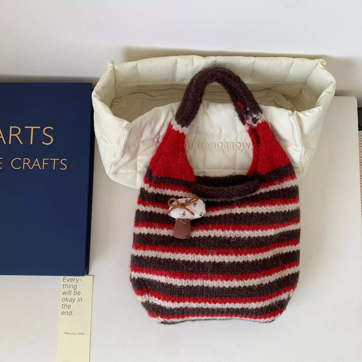 Knitted striped handbag by Plush Fashion Hub featuring colorful woven design and sturdy handles for casual style.