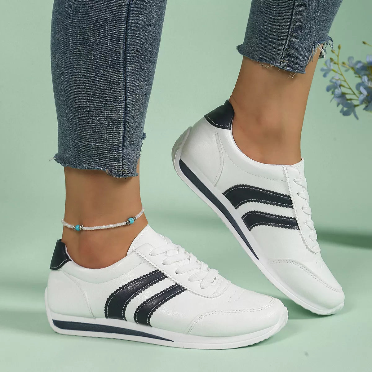 Women round toe lace-up sneakers by Trendsi, featuring stylish design and comfortable fit, shown in a side view.