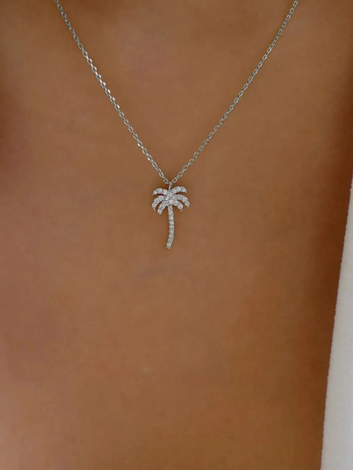 Zircon Palm Tree Pendant Necklace featuring a sparkling palm tree charm on a delicate chain, jewelry by Plush Fashion Hub