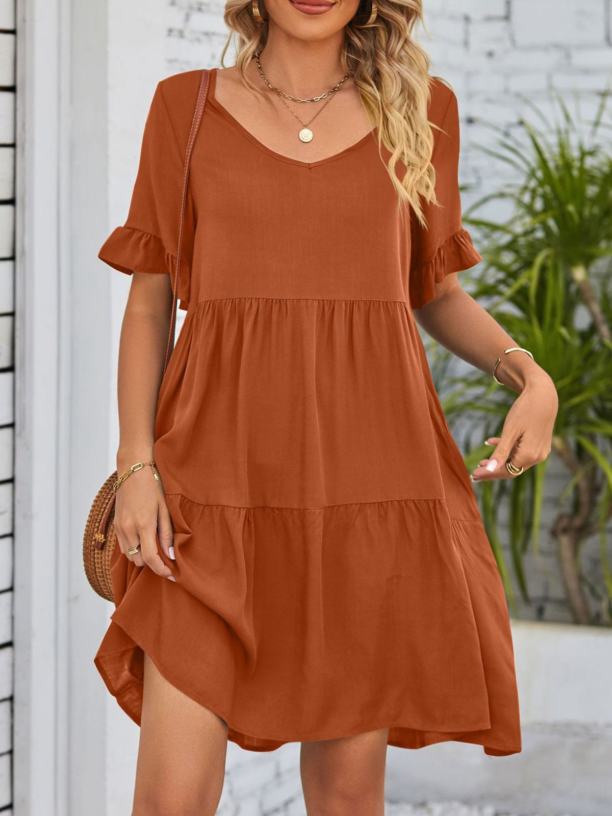 Lightweight rayon mini dress with ruffled sleeves, tiered design, and pockets from Plush Fashion Hub.