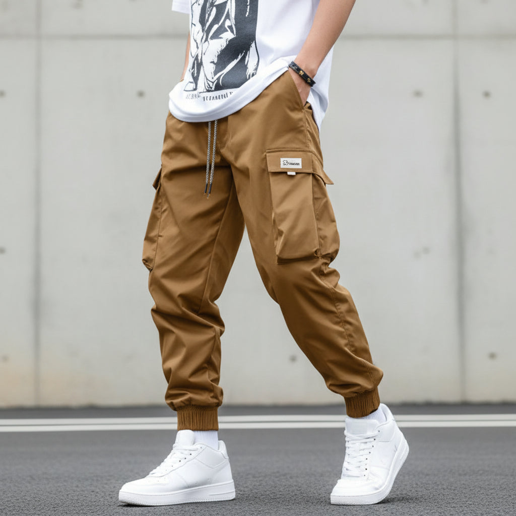 Men’s multi-pocket drawstring cargo pants from FitiqueFit, streetwear style, featuring multiple side pockets and a relaxed fit.