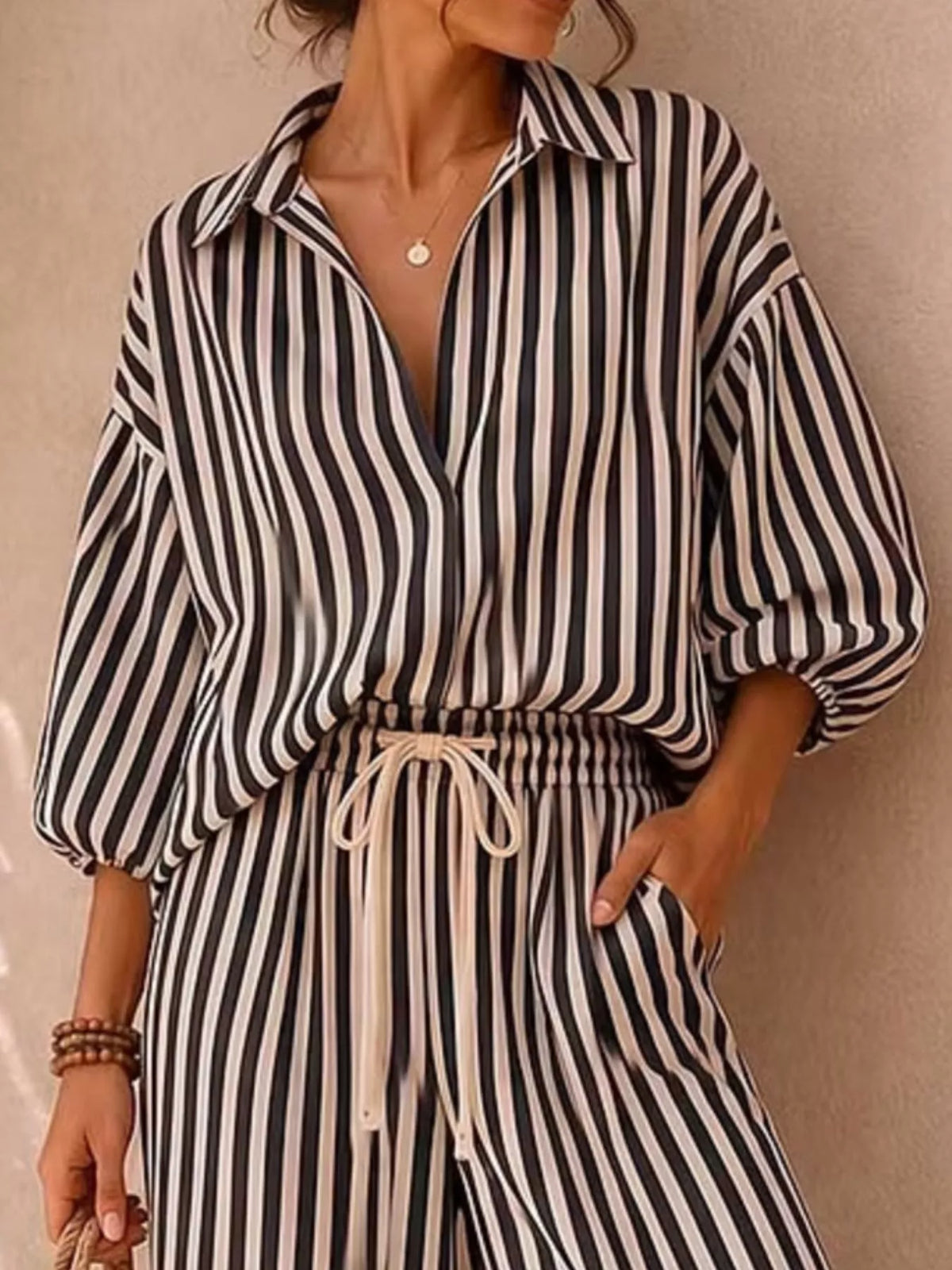 Plus size striped puff sleeve shirt and wide-leg drawstring pants set by Trendsi, featuring a stylish matching ensemble.