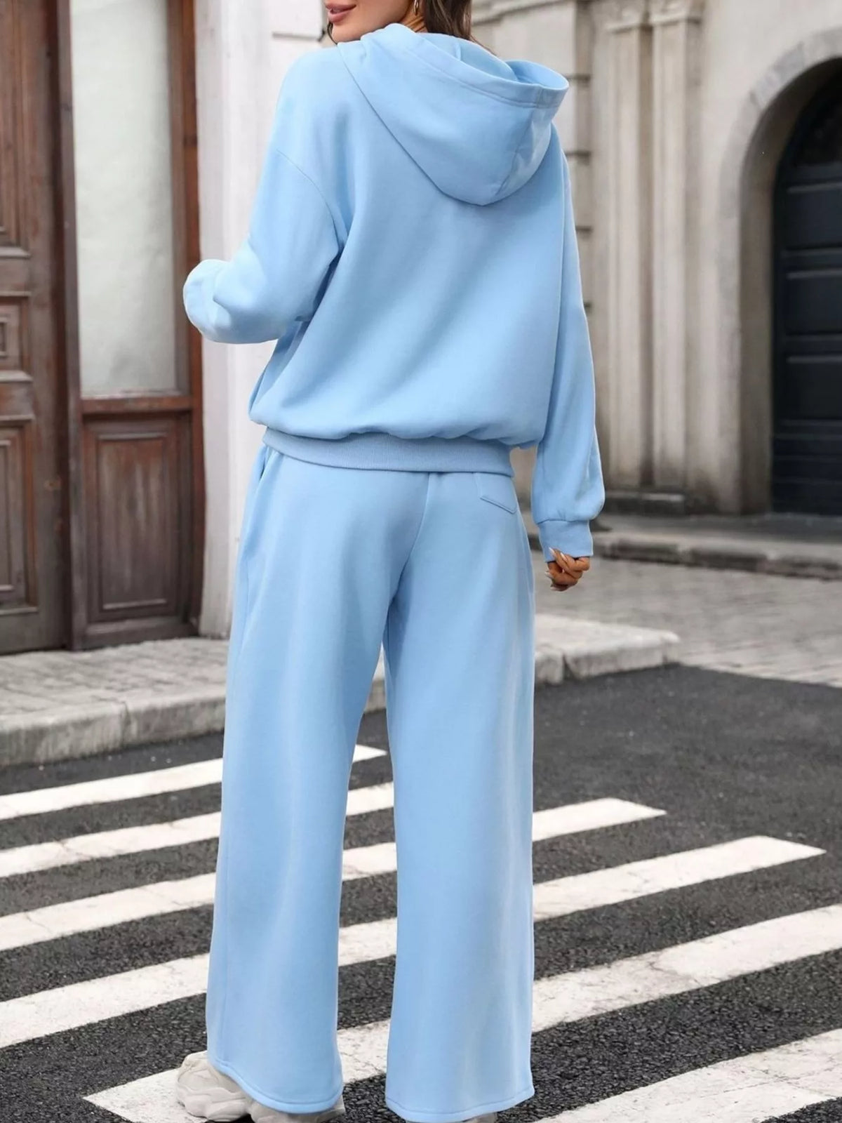 Trendsi women's hoodie and wide-leg pant set featuring a kangaroo pocket in soft, comfortable fabric, perfect for casual wear.