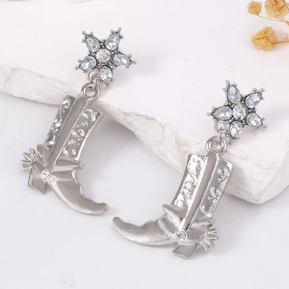 Western style dangle earrings featuring boot-shaped charms from Plush Fashion Hub, stylish jewelry for fashion-forward outfits.