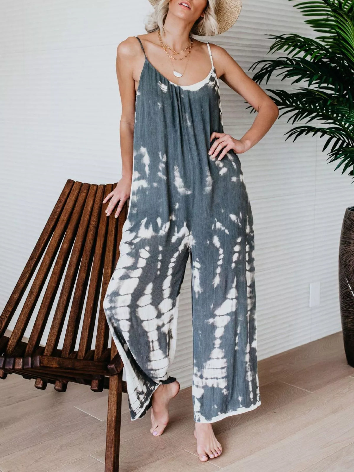 Plus size tie-dye wide leg jumpsuit by Plush Fashion Hub, full-length with vibrant colorful pattern and relaxed fit.