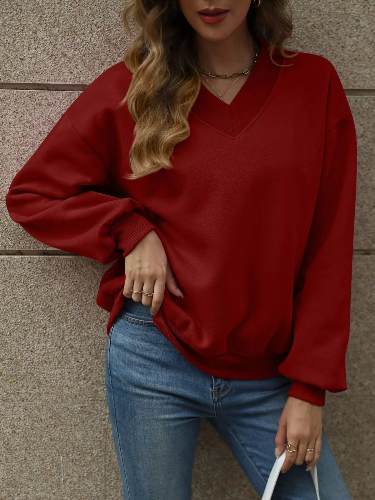 V-neck solid color casual sweatshirt by Trendsi, shown in relaxed fit with long sleeves and soft fabric.