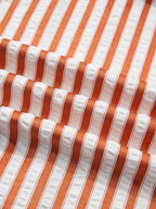 Stripe pinched V-neck mini dress by Trendsi featuring turn-up cuffs and side pockets, shown on a model.
