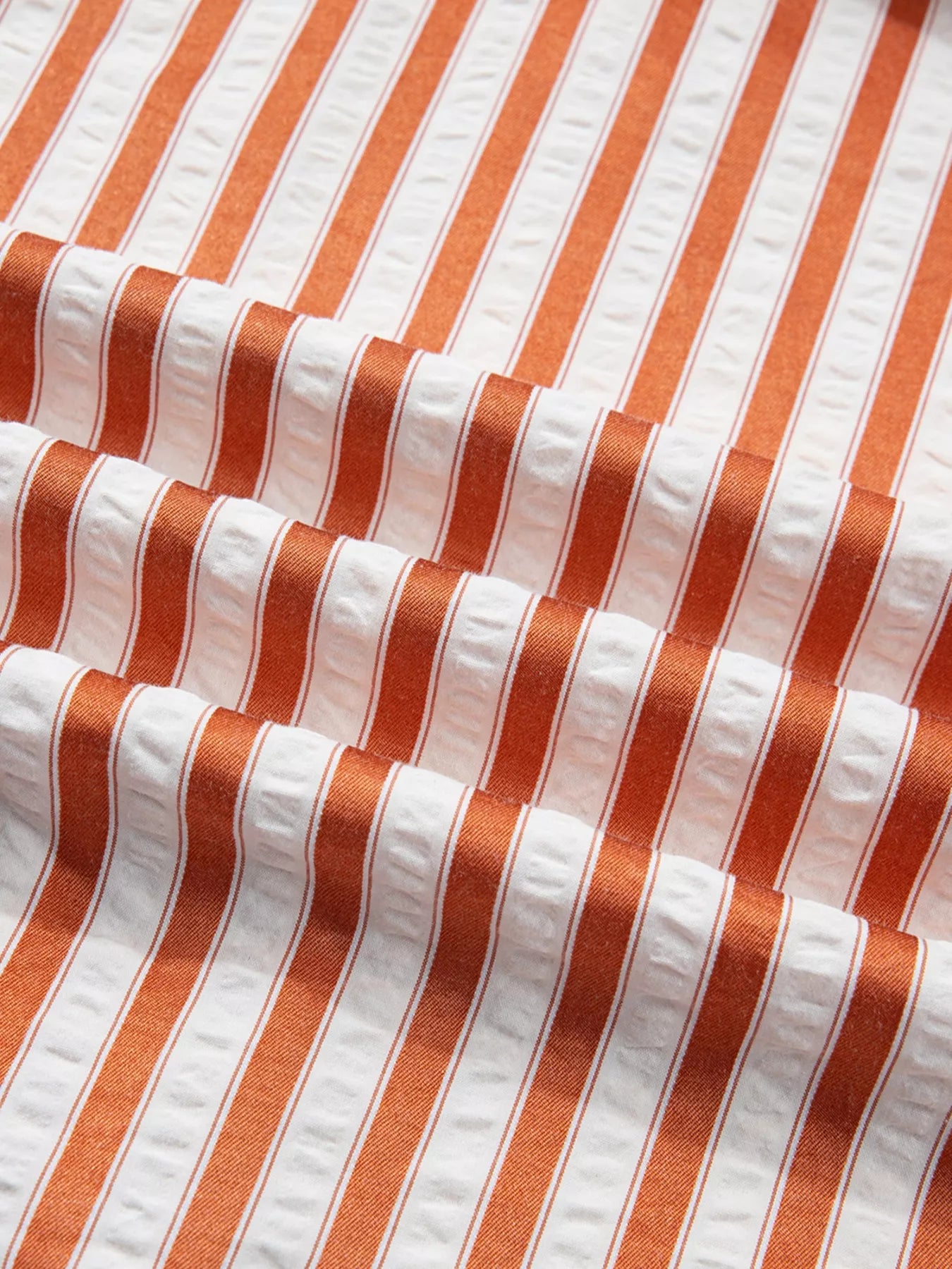 Stripe pinched V-neck mini dress by Trendsi featuring turn-up cuffs and side pockets, shown on a model.