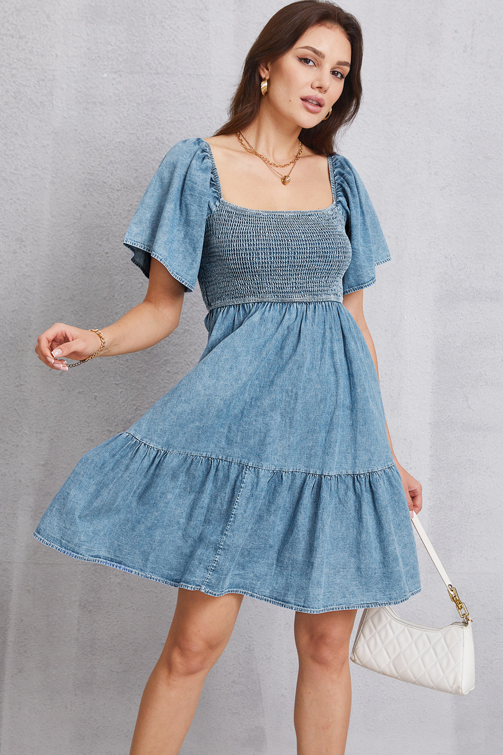 Smocked square neck mini denim dress by Plush Fashion Hub, featuring a fitted bodice and stylish short sleeves.