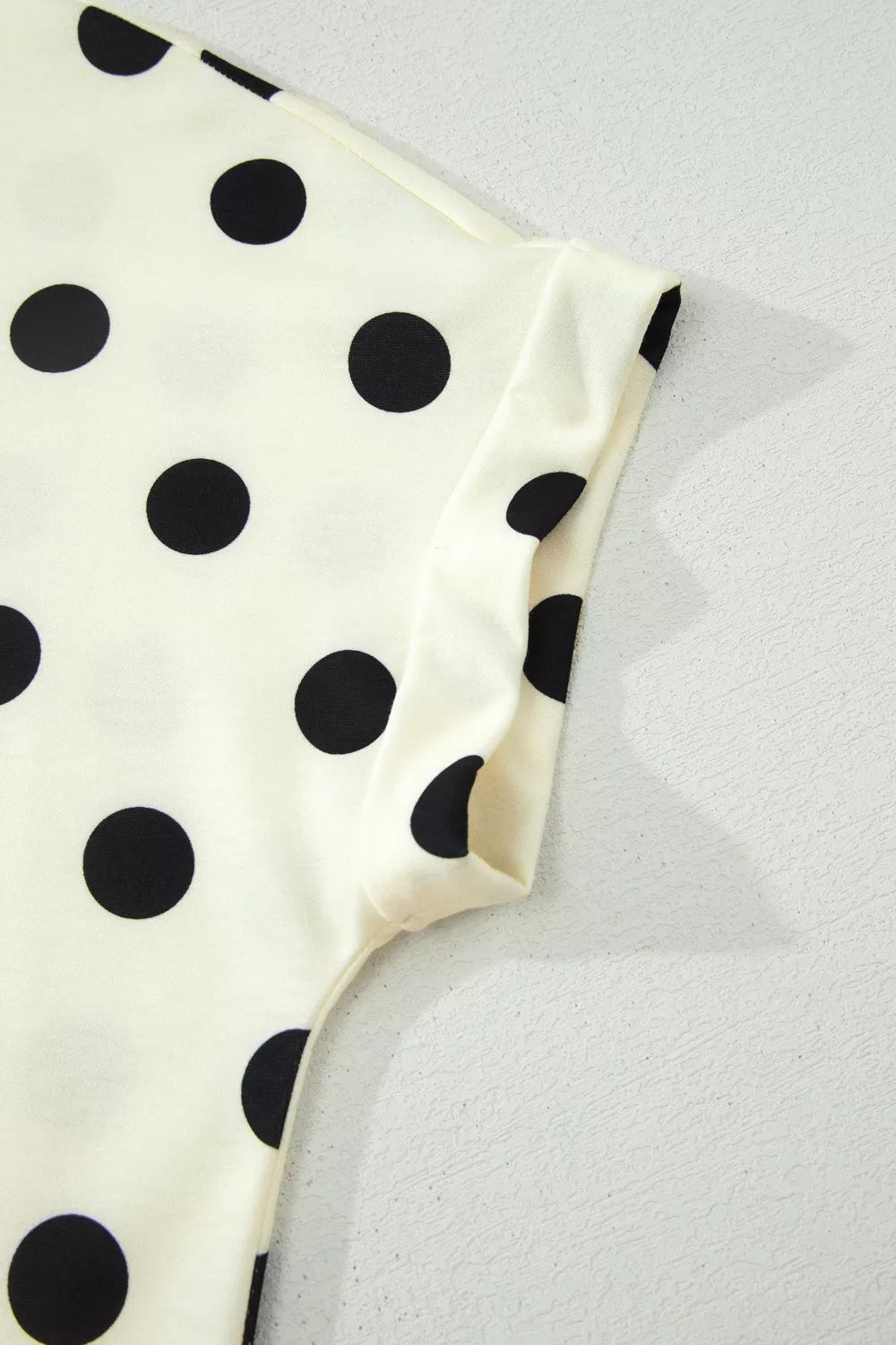 Polka dot print high neck dolman top from Trendsi, featuring a relaxed fit and long sleeves, perfect for casual wear.