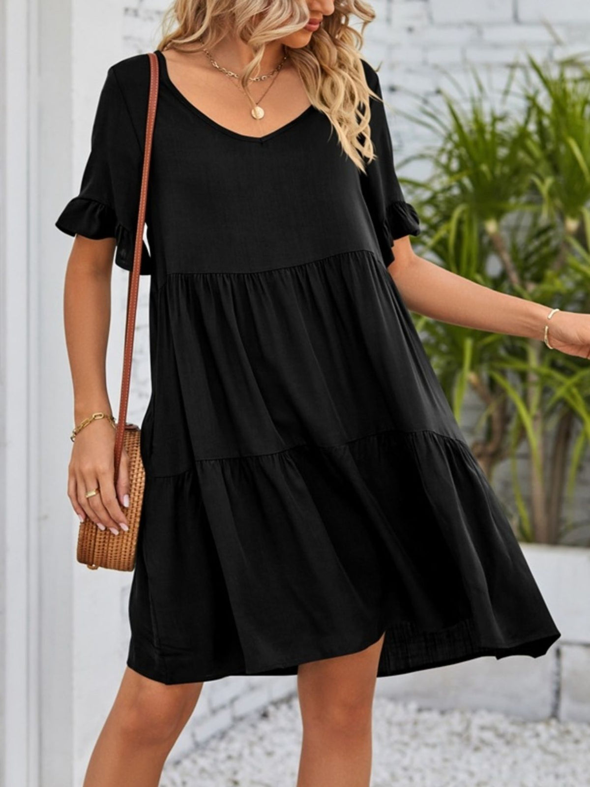Lightweight rayon mini dress with ruffled sleeves, tiered design, and pockets from Plush Fashion Hub, perfect for casual summer wear.