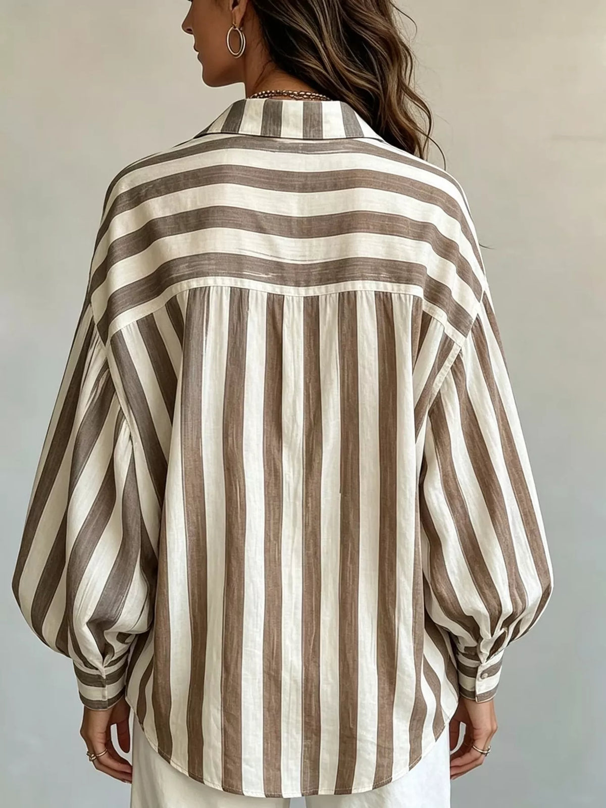 Women’s loose fit striped shirt by Trendsi, featuring a casual relaxed style with horizontal stripes and a comfortable fit.