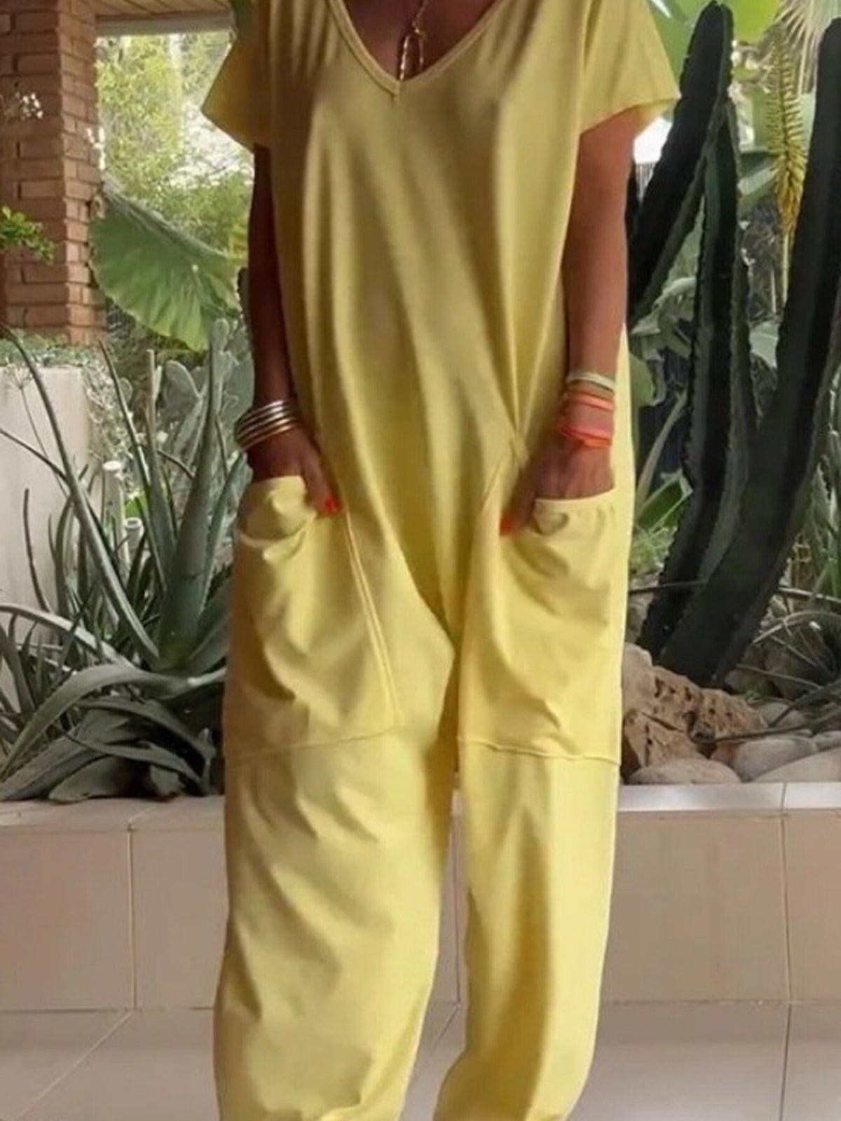 Plus size loose fit V-neck short sleeve jumpsuit with wide leg design, styled for a comfortable, casual look.