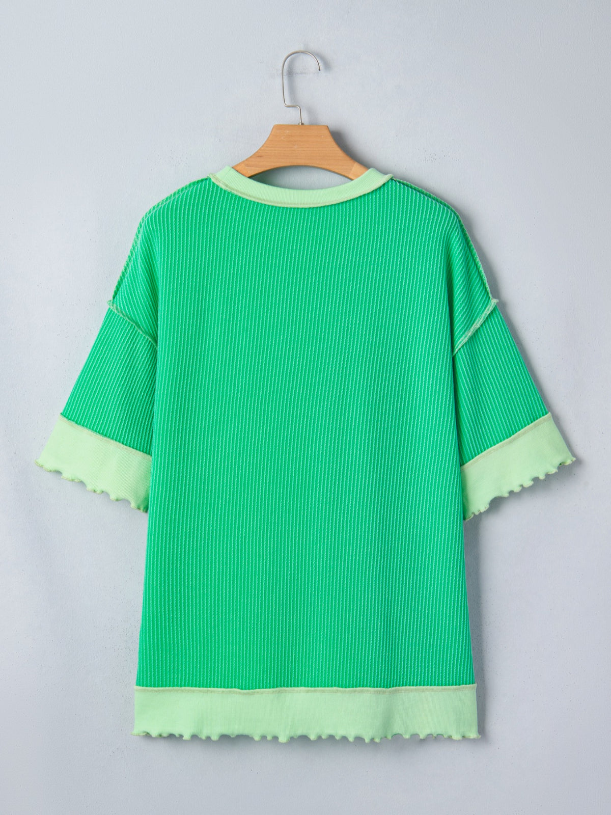 Women’s ribbed short sleeve T-shirt with twist hem and contrast stitching, Plush Fashion Hub, showing front view with textured fabric.