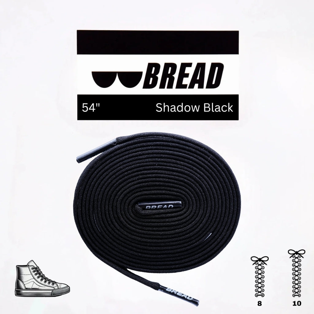 Black elastic shoelace by Bread, classic shadow black color, shown threaded through shoe eyelets for a snug fit.
