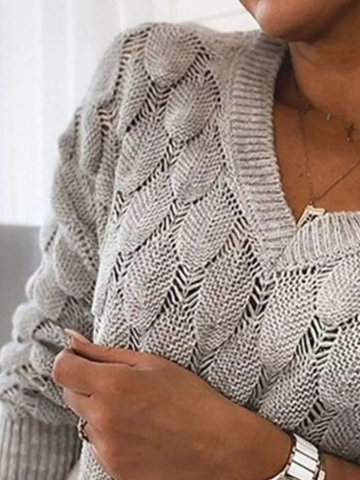 V-neck knitted sweater by Trendsi featuring a cozy, soft knit fabric in a stylish design, perfect for casual and layered looks.