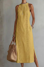Women's sleeveless side slit maxi dress with pockets by Trendsi, featuring a flowy fabric and a stylish slit detail.