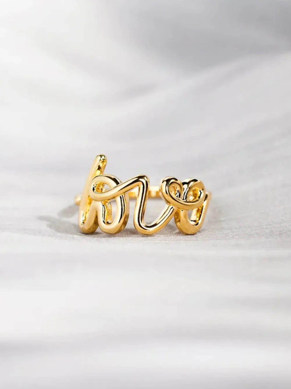 Love 18K gold-plated sterling silver ring featuring a sleek band, crafted by Plush Fashion Hub.
