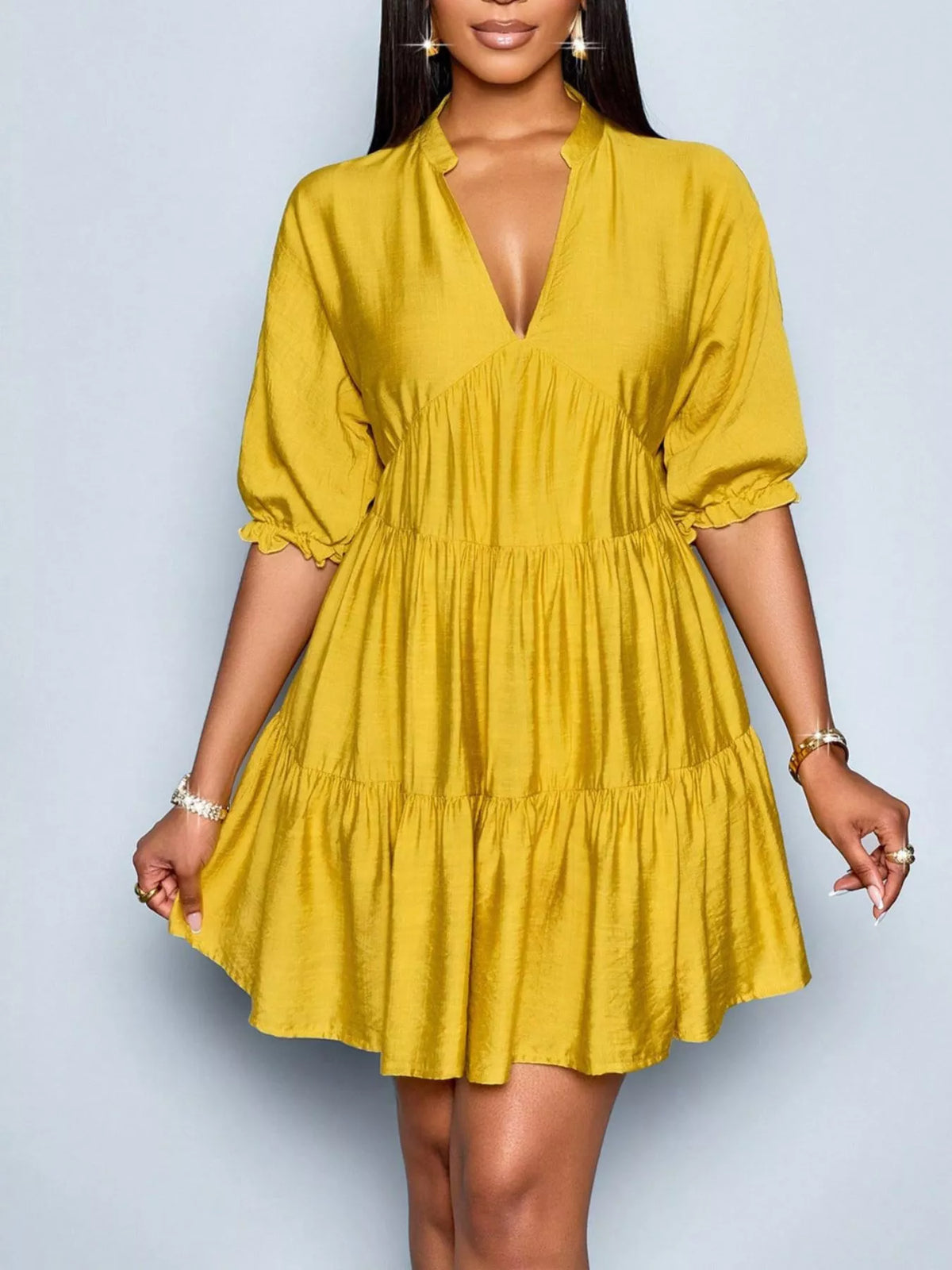 Notched half sleeve tiered dress by Plush Fashion Hub featuring a stylish design and flowing fabric in soft colors.