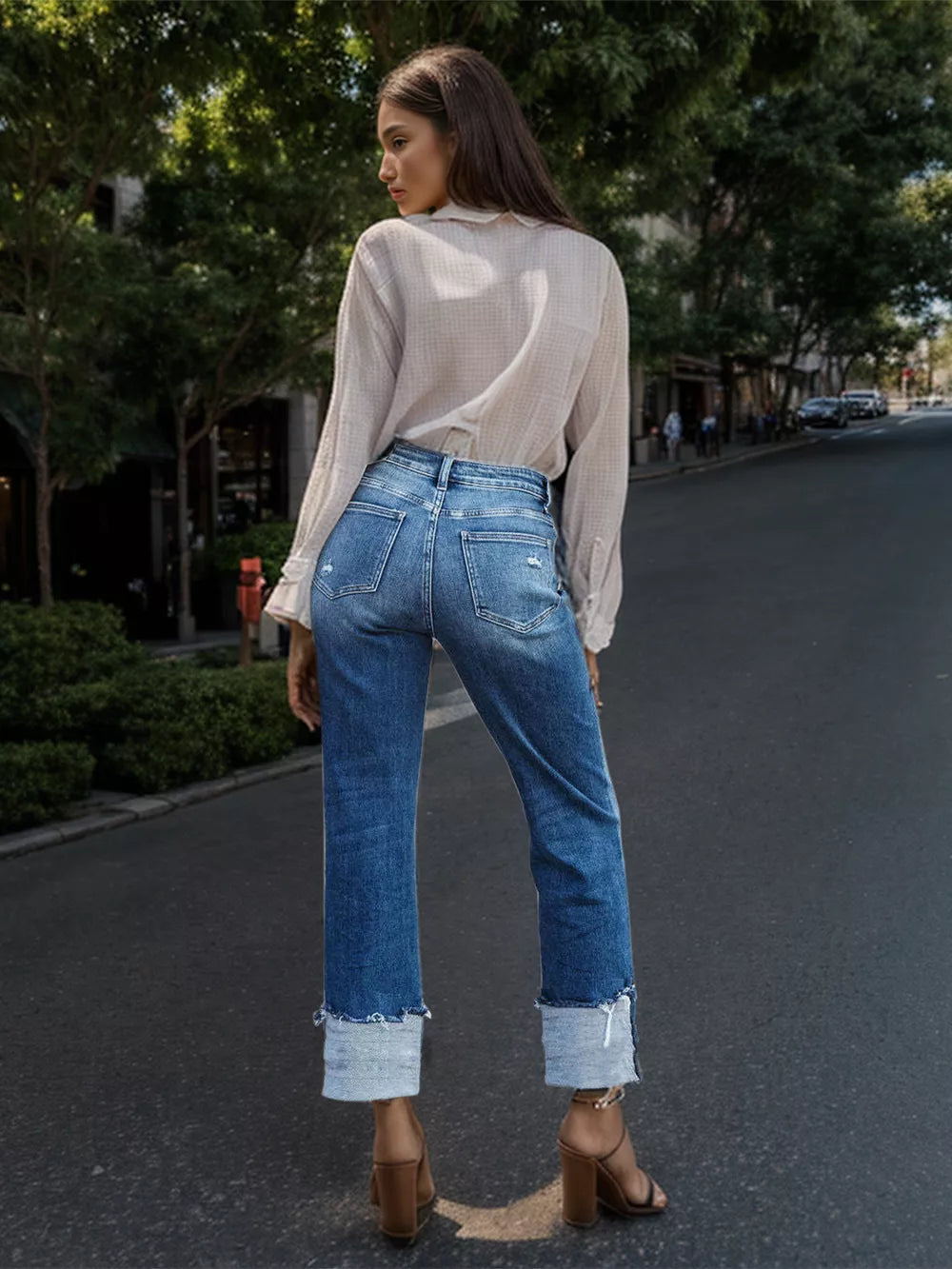 Straight denim jeans with stepped waist and raw hem, showcased on a model, from Trendsi, in a casual fit and classic blue color.
