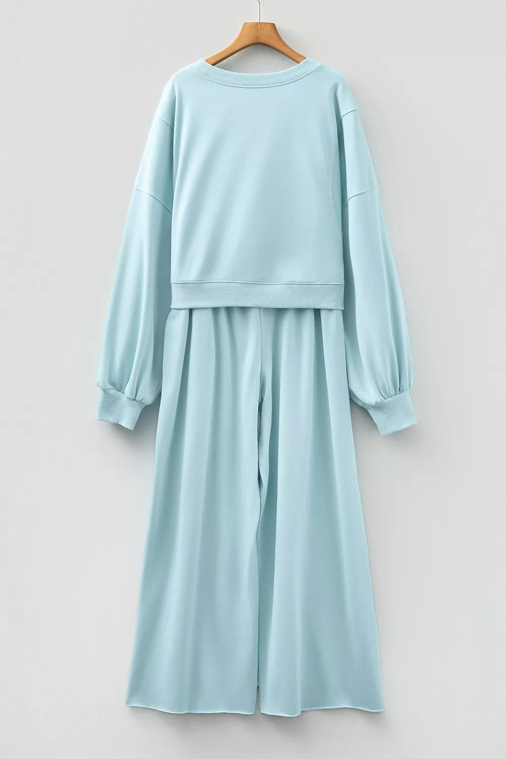 Drop shoulder puff sleeve crop pullover and wide-leg pants set from Trendsi, featuring a stylish, coordinated fashion ensemble.