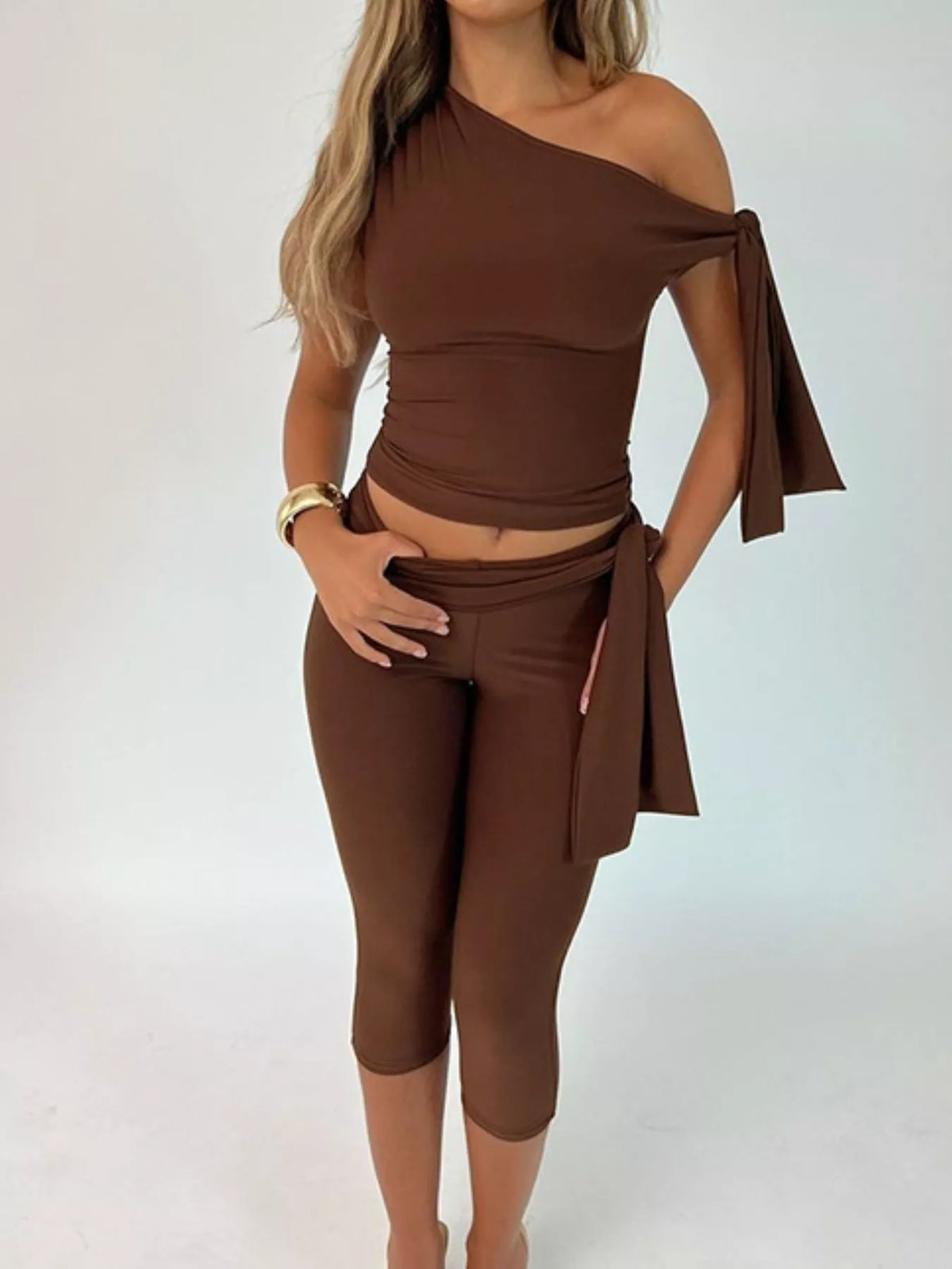 Plush Fashion Hub tied one-shoulder top and matching capris set in soft fabric, stylish and casual for warm-weather wear.