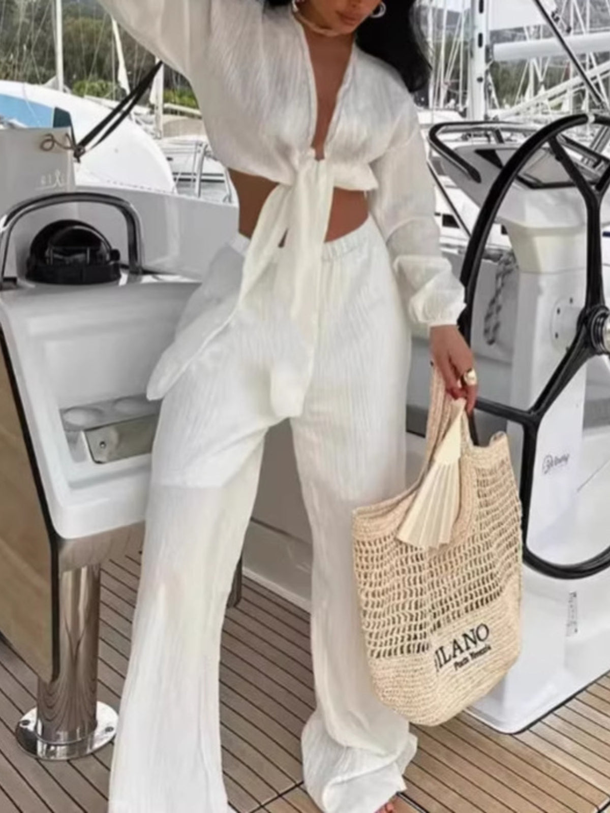 Textured tie-front crop top and wide-leg pants two-piece set by Plush Fashion Hub, worn together in a stylish fashion ensemble.