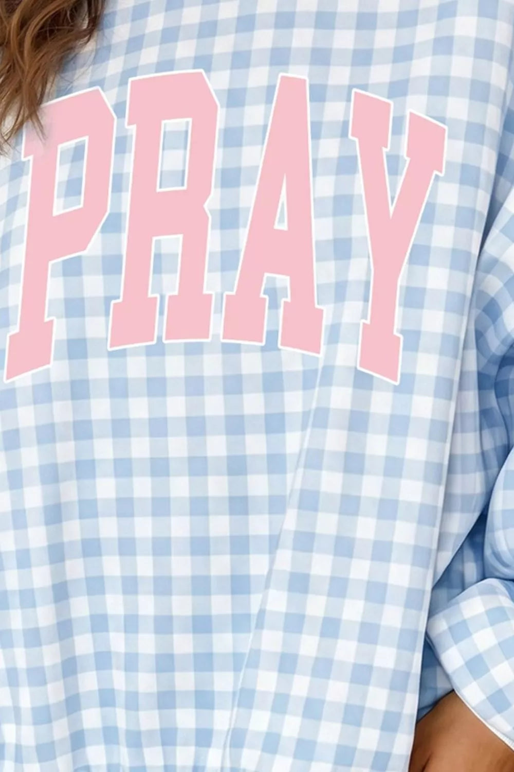 Women's round neck sweatshirt with PRAY slogan graphic from Trendsi, featuring a comfortable fit and casual style.