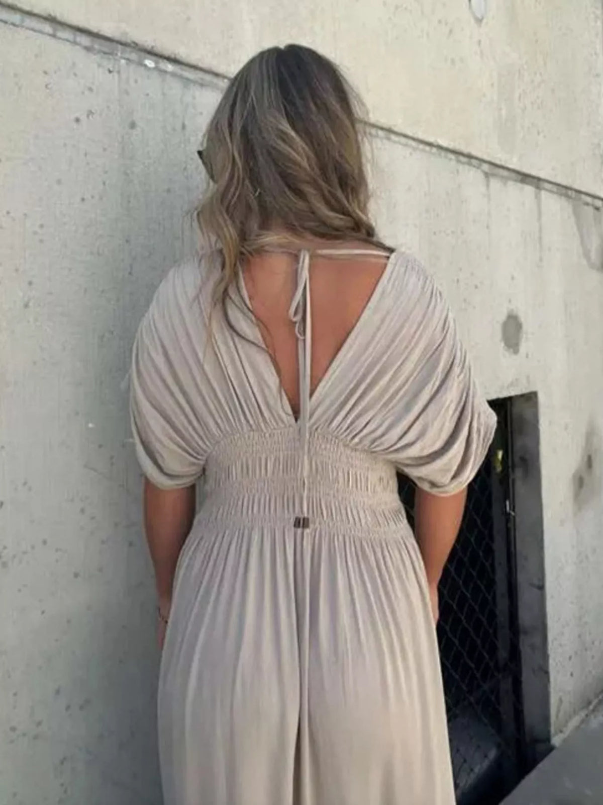 Plus size full slit V-neck maxi dress with smocked waist by Plush Fashion Hub, featuring a flowing silhouette and vibrant fabric.